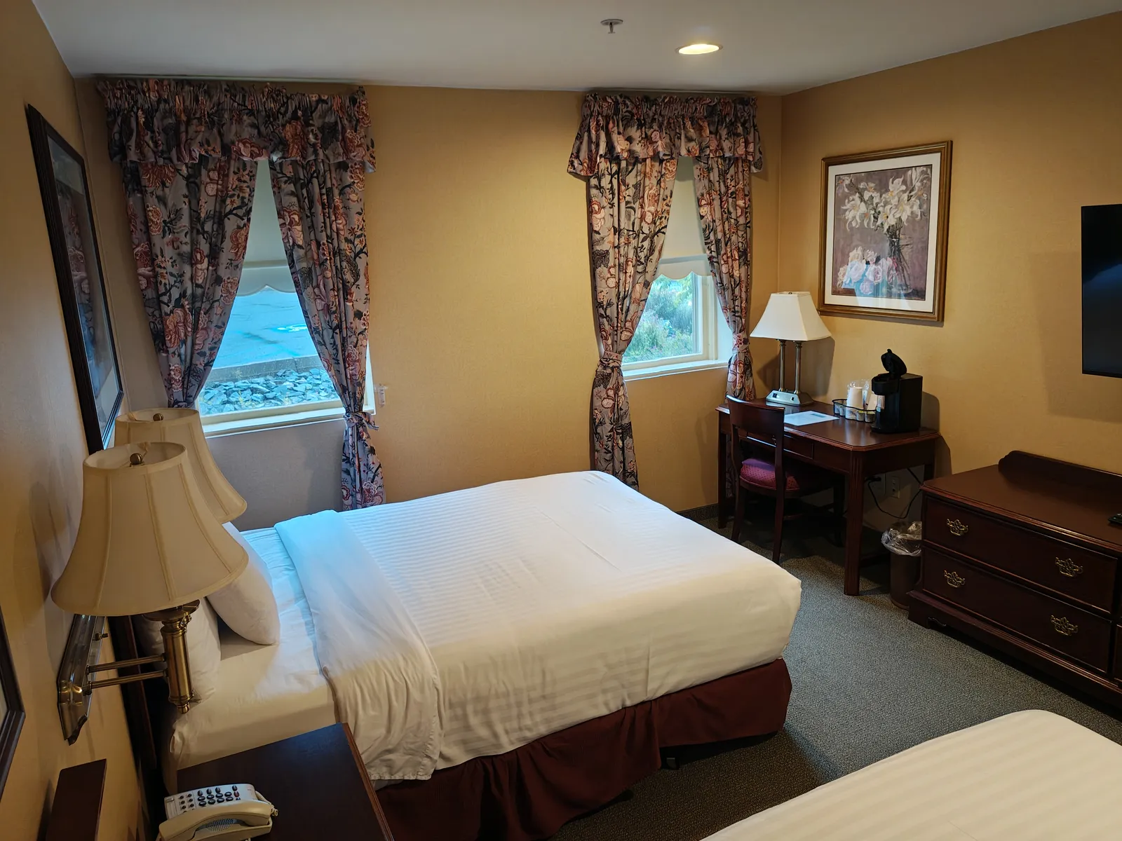 Double Queen Room bed beside a window with Glen views