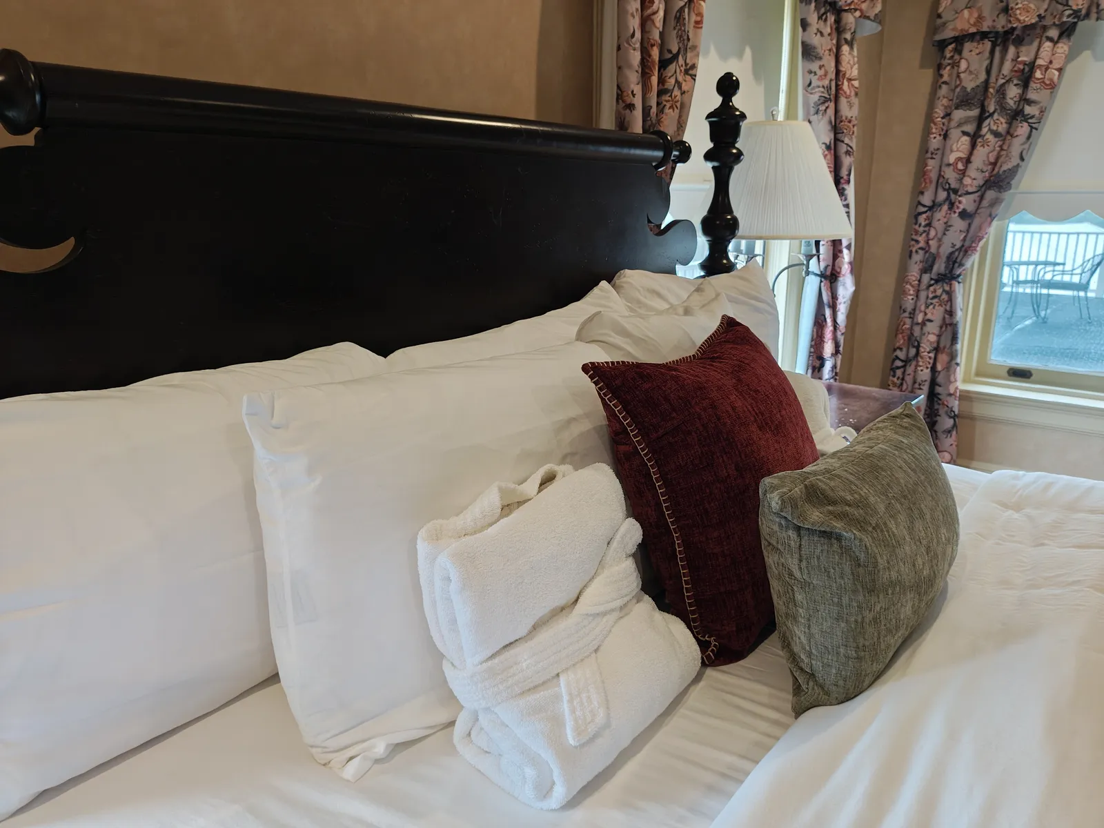 Thomas Watson Suite pillows and robes with terrace view through window